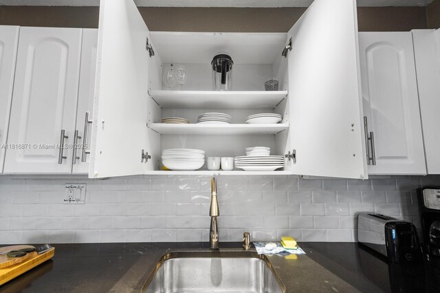 3725 S Ocean Dr Unit 1224, Hollywood, FL 33019 - kitchen view of a sink, white cabinetry, tasteful backsplash, and open shelves
