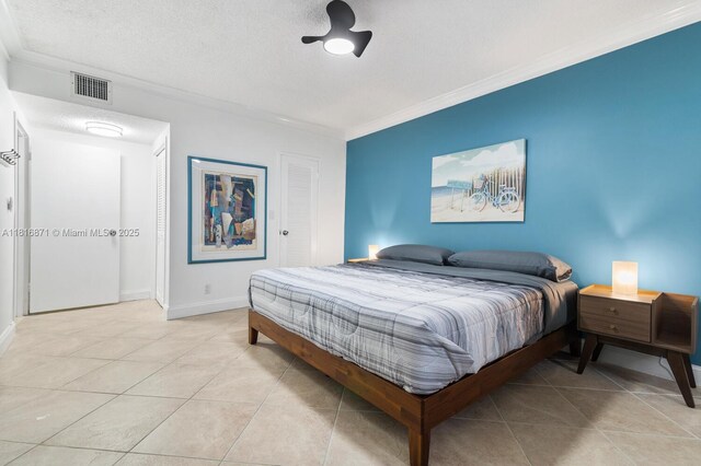 3725 S Ocean Dr Unit 1224, Hollywood, FL 33019 - bedroom featuring ornamental molding, light tile patterned floors, baseboards, and a textured ceiling