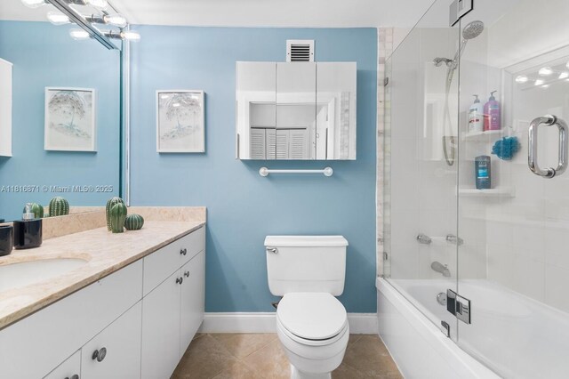 3725 S Ocean Dr Unit 1224, Hollywood, FL 33019 - bathroom featuring vanity, baseboards, toilet, tile patterned floors, and enclosed tub / shower combo
