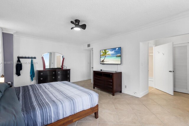 3725 S Ocean Dr Unit 1224, Hollywood, FL 33019 - bedroom with ornamental molding, light tile patterned floors, a textured ceiling, and baseboards