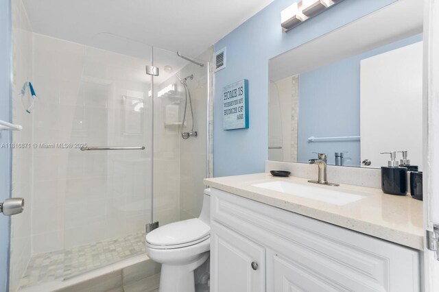 3725 S Ocean Dr Unit 1224, Hollywood, FL 33019 - bathroom featuring vanity, a stall shower, and toilet