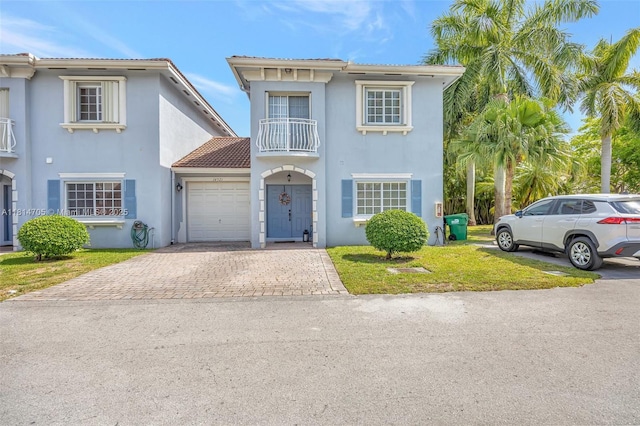 14521 SW 29th Ter Unit 14521, Miami, FL 33175 - view of front of home featuring a balcony, decorative driveway, a garage, stucco siding, and a tiled roof