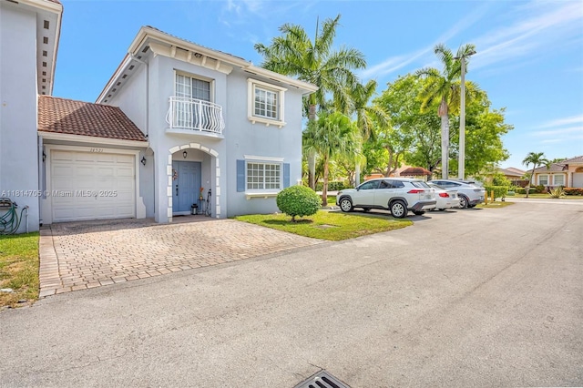 14521 SW 29th Ter Unit 14521, Miami, FL 33175 - view of front of house featuring a balcony, stucco siding, and an attached garage