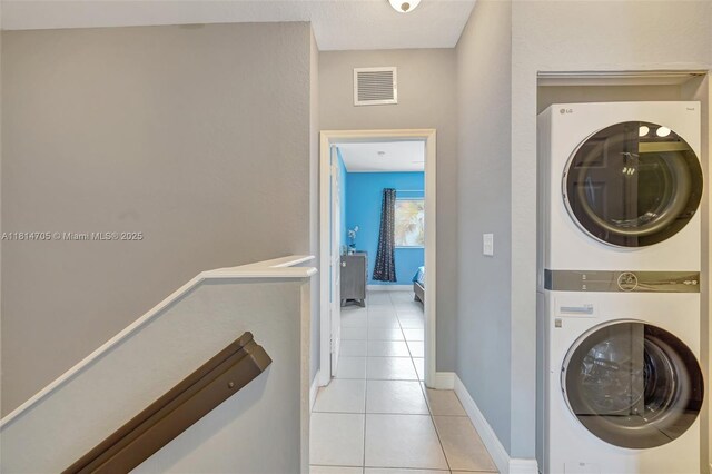 14521 SW 29th Ter Unit 14521, Miami, FL 33175 - laundry area with stacked washing machine and dryer and light tile patterned flooring