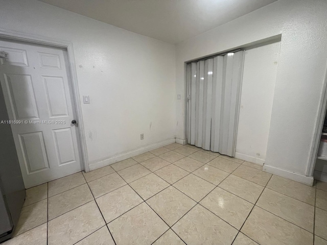 451 E Dayton Cir, Fort Lauderdale, FL 33312 - unfurnished bedroom featuring light tile patterned flooring and a closet