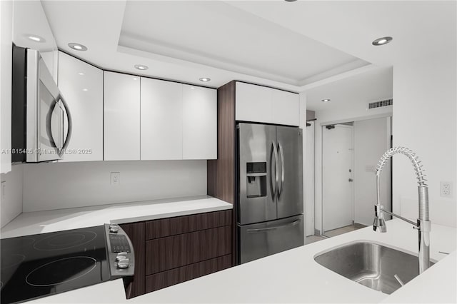 401 Ocean Dr Unit 221, Miami Beach, FL 33139 - kitchen with stainless steel appliances, a sink, modern cabinets, white cabinetry, and recessed lighting