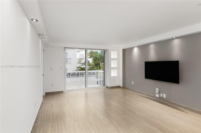 401 Ocean Dr Unit 221, Miami Beach, FL 33139 - unfurnished living room with baseboards and recessed lighting