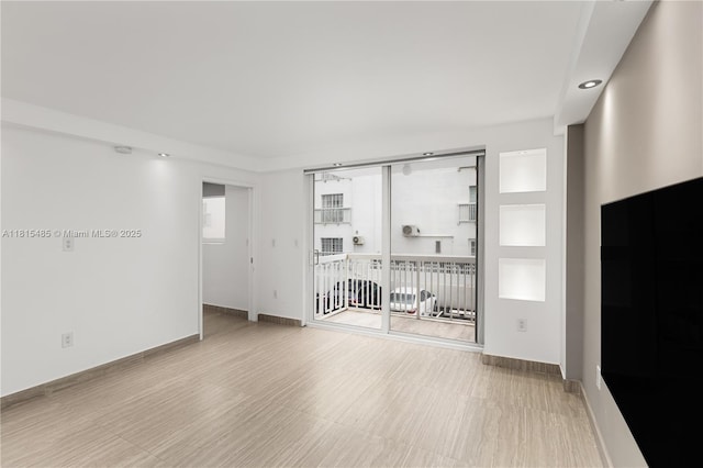 401 Ocean Dr Unit 221, Miami Beach, FL 33139 - unfurnished room with wood finished floors, baseboards, and recessed lighting