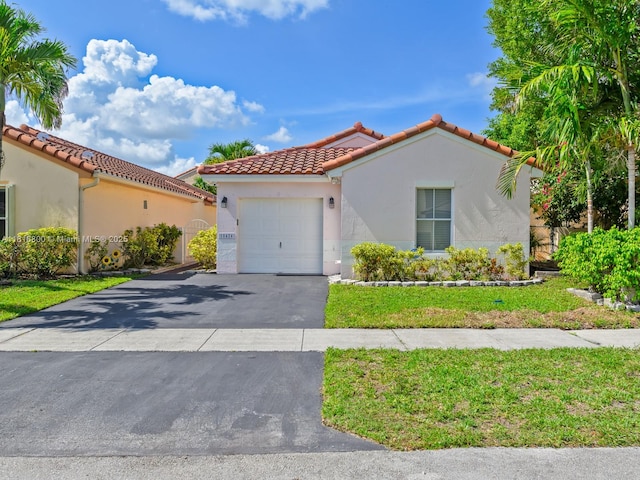 18424 NW 21st St, Pembroke Pines, FL 33029 - mediterranean / spanish house with an attached garage, a tiled roof, stucco siding, driveway, and a front yard