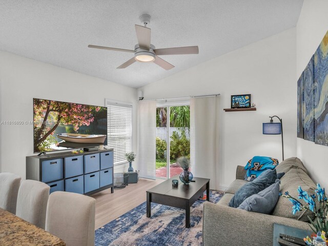 18424 NW 21st St, Pembroke Pines, FL 33029 - living area with light wood-style flooring, a ceiling fan, vaulted ceiling, and a textured ceiling