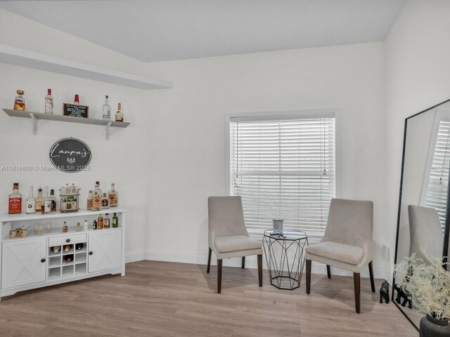18424 NW 21st St, Pembroke Pines, FL 33029 - living area with a dry bar, light wood-style floors, and baseboards