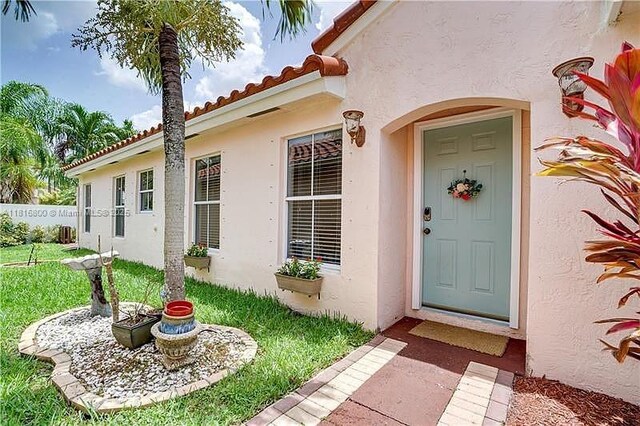 18424 NW 21st St, Pembroke Pines, FL 33029 - doorway to property with stucco siding and a tile roof