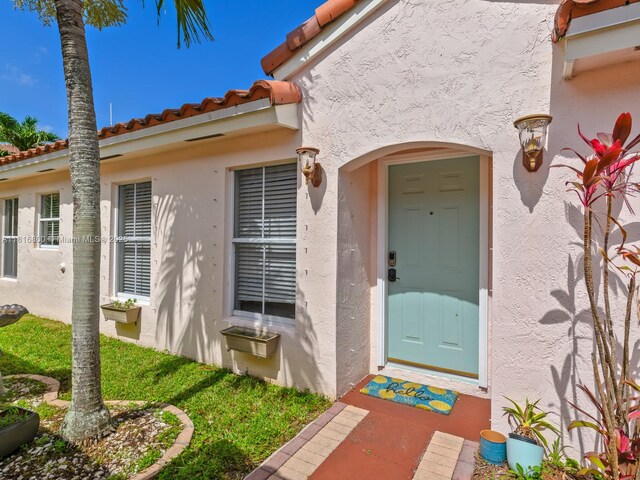 18424 NW 21st St, Pembroke Pines, FL 33029 - doorway to property featuring stucco siding and a tile roof