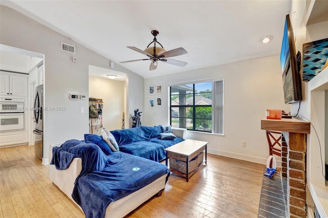 717 SW Aster Rd, Port St Lucie, FL 34953 - living room featuring light wood-style flooring, a ceiling fan, lofted ceiling, baseboards, and recessed lighting