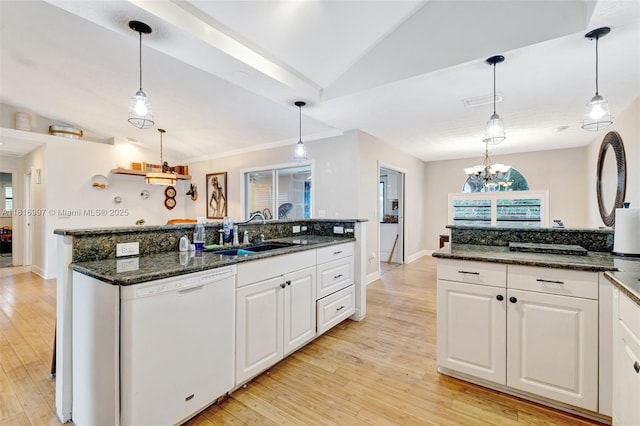 717 SW Aster Rd, Port St Lucie, FL 34953 - kitchen featuring white dishwasher, a sink, vaulted ceiling, light wood finished floors, and white cabinetry