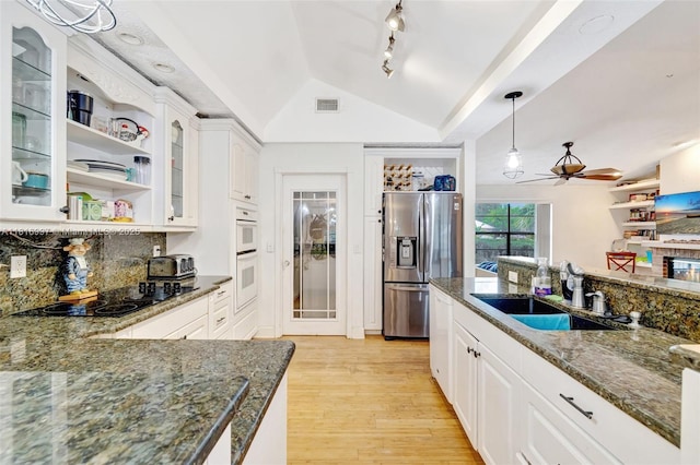 717 SW Aster Rd, Port St Lucie, FL 34953 - kitchen featuring stainless steel fridge, open shelves, a ceiling fan, tasteful backsplash, and light wood-style flooring