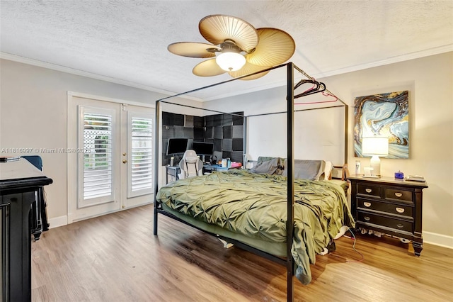 717 SW Aster Rd, Port St Lucie, FL 34953 - bedroom with wood finished floors, access to exterior, crown molding, baseboards, and a textured ceiling