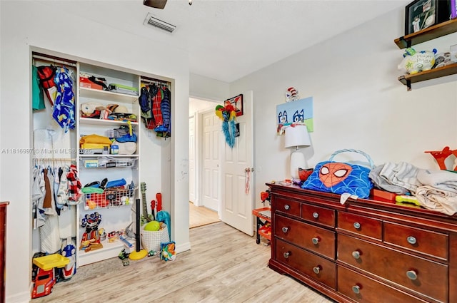 717 SW Aster Rd, Port St Lucie, FL 34953 - bedroom with wood finished floors, ceiling fan, a closet, and baseboards