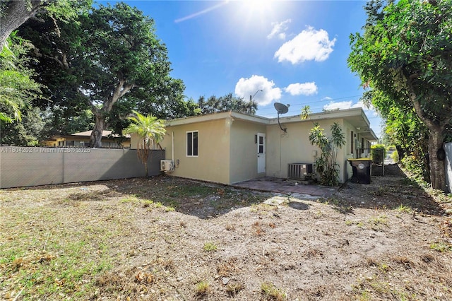 3655 Stirling Rd, Hollywood, FL 33312 - back of property with stucco siding and central air condition unit