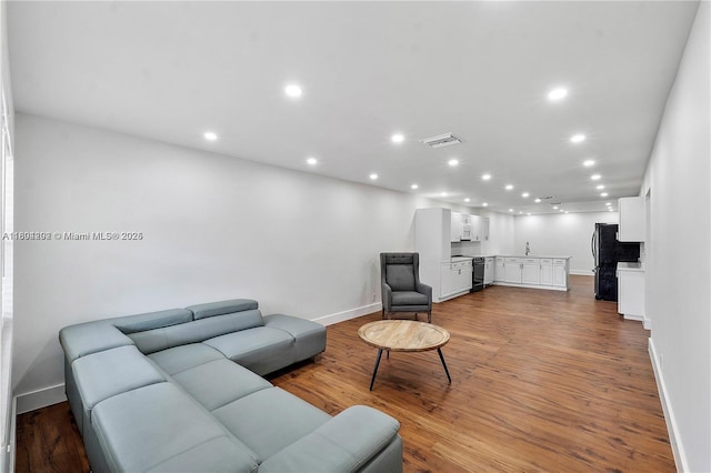 3655 Stirling Rd, Hollywood, FL 33312 - living area with baseboards, recessed lighting, and wood finished floors