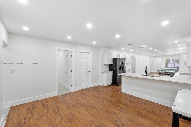 3655 Stirling Rd, Hollywood, FL 33312 - kitchen with refrigerator with ice dispenser, a sink, recessed lighting, white cabinets, and light countertops