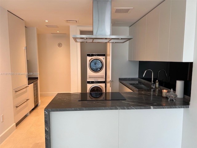 700 NE 26th Ter Unit 2004, Miami, FL 33137 - kitchen featuring stacked washing machine and dryer, a sink, black electric cooktop, island exhaust hood, and wine cooler