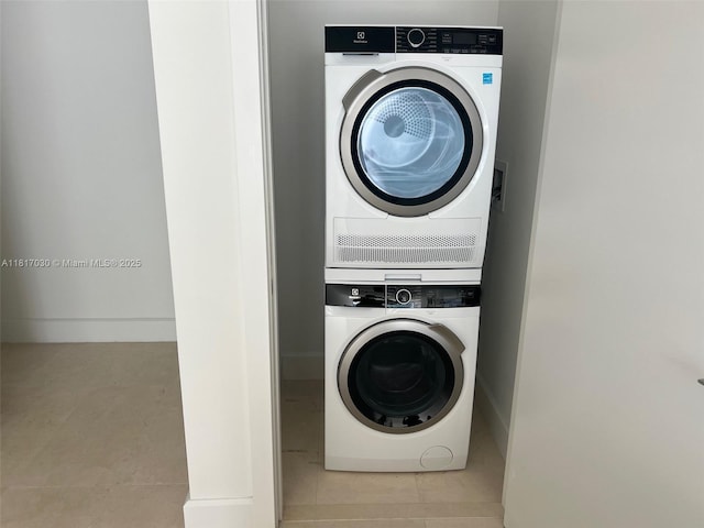 700 NE 26th Ter Unit 2004, Miami, FL 33137 - washroom featuring stacked washer / dryer, tile patterned flooring, and baseboards