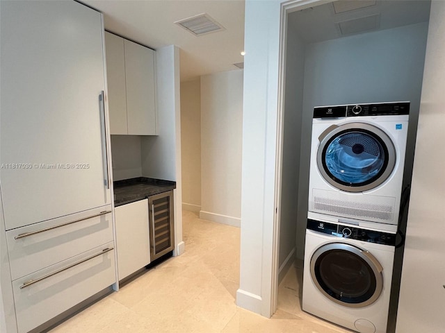 700 NE 26th Ter Unit 2004, Miami, FL 33137 - laundry area with stacked washer / dryer, beverage cooler, baseboards, and attic access