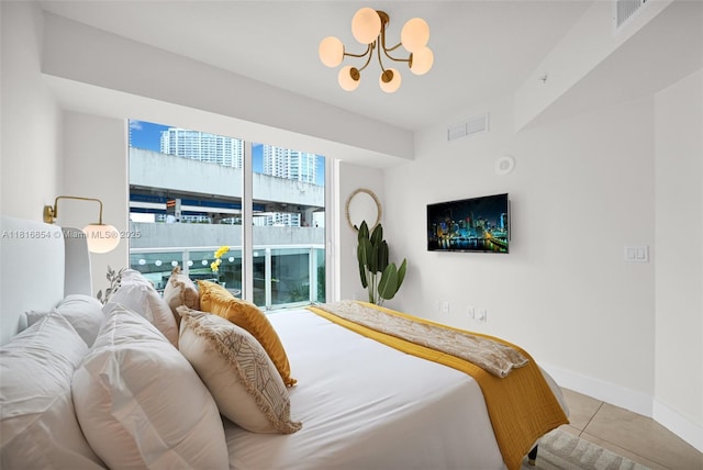 41 SE 5th St Unit 517, Miami, FL 33131 - bedroom featuring a chandelier, tile patterned floors, and baseboards