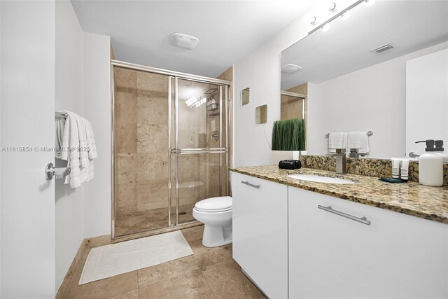 41 SE 5th St Unit 517, Miami, FL 33131 - bathroom with vanity, a shower stall, and toilet