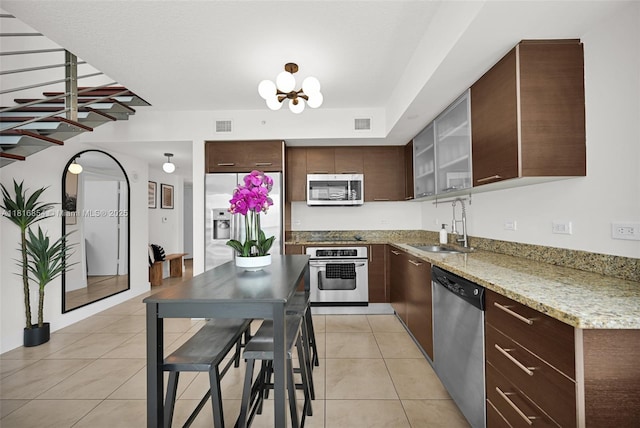 41 SE 5th St Unit 517, Miami, FL 33131 - kitchen with stainless steel appliances, a sink, and dark brown cabinetry