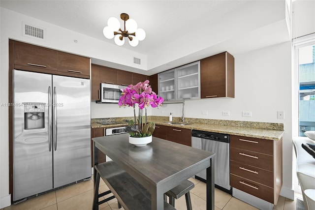 41 SE 5th St Unit 517, Miami, FL 33131 - kitchen featuring appliances with stainless steel finishes, a sink, a chandelier, and dark brown cabinetry