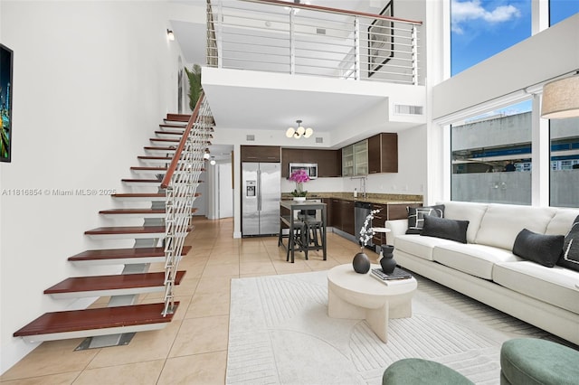 41 SE 5th St Unit 517, Miami, FL 33131 - living room featuring a towering ceiling, light tile patterned floors, and stairway