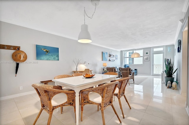 4250 Galt Ocean Dr Unit 7D, Fort Lauderdale, FL 33308 - dining room featuring baseboards, light tile patterned floors, and crown molding