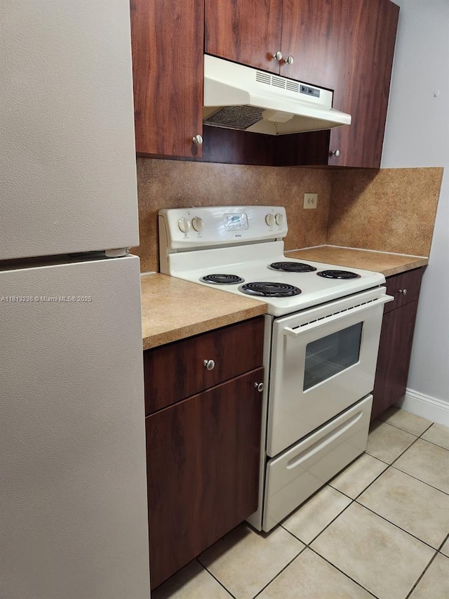 7095 NW 179th St Unit 206, Hialeah, FL 33015 - kitchen featuring white appliances, under cabinet range hood, light tile patterned flooring, decorative backsplash, and light countertops
