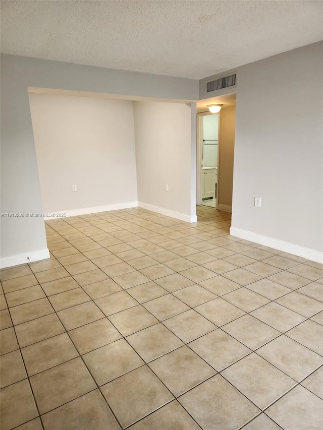 7095 NW 179th St Unit 206, Hialeah, FL 33015 - spare room featuring light tile patterned flooring and a textured ceiling