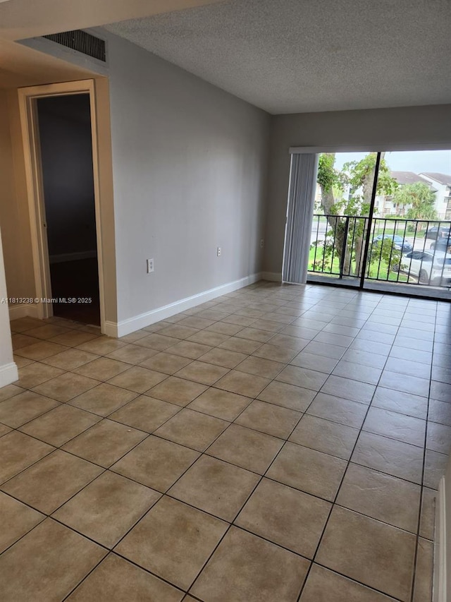 7095 NW 179th St Unit 206, Hialeah, FL 33015 - empty room featuring baseboards, a textured ceiling, and light tile patterned floors