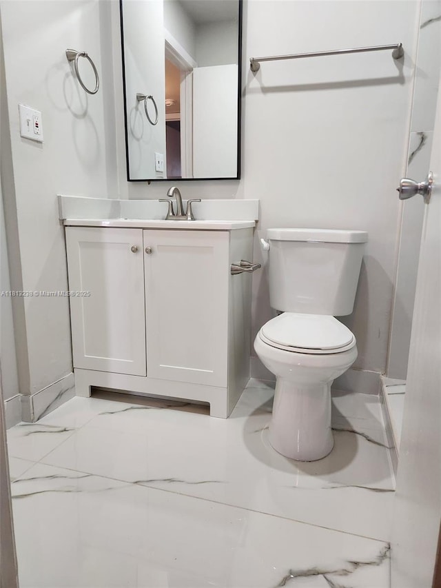 7095 NW 179th St Unit 206, Hialeah, FL 33015 - bathroom featuring toilet, vanity, marble look tile flooring, and baseboards
