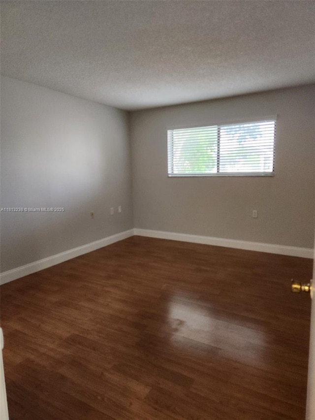 7095 NW 179th St Unit 206, Hialeah, FL 33015 - unfurnished room featuring wood finished floors, a textured ceiling, and baseboards