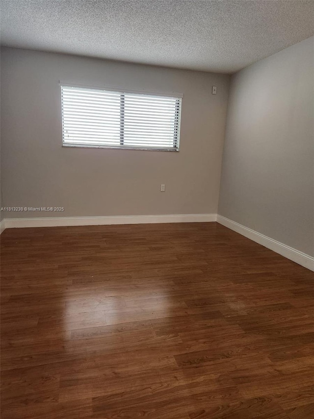 7095 NW 179th St Unit 206, Hialeah, FL 33015 - empty room featuring wood finished floors, baseboards, and a textured ceiling