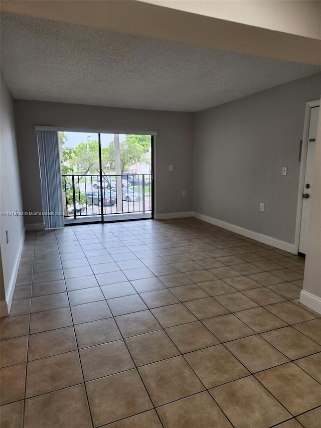 7095 NW 179th St Unit 206, Hialeah, FL 33015 - empty room with baseboards, a textured ceiling, and light tile patterned floors