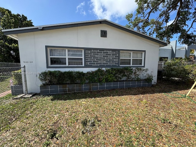 1226 NE 112th St, Miami, FL 33161 - view of side of property featuring stucco siding