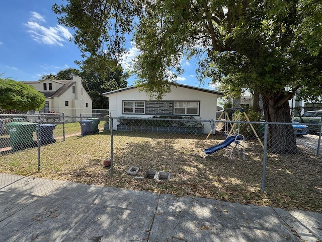 1226 NE 112th St, Miami, FL 33161 - view of front facade with a playground and stucco siding