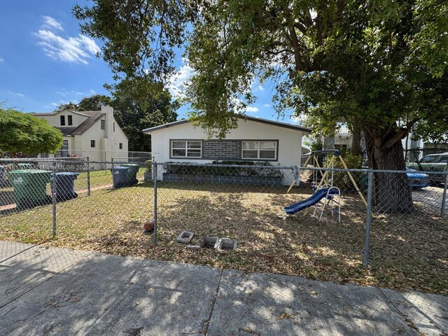 1226 NE 112th St, Miami, FL 33161 - view of front of property with a playground and stucco siding