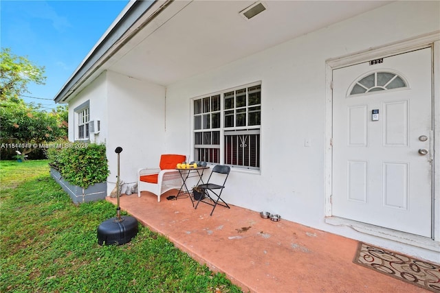1226 NE 112th St, Miami, FL 33161 - doorway to property with stucco siding and a yard