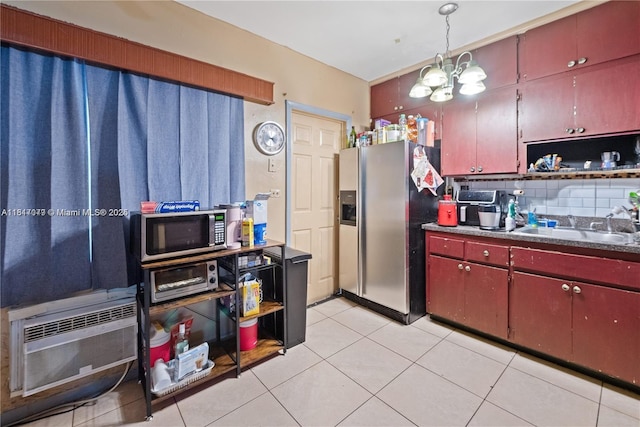 1226 NE 112th St, Miami, FL 33161 - kitchen featuring appliances with stainless steel finishes, decorative backsplash, a chandelier, and red cabinetry