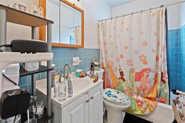 1226 NE 112th St, Miami, FL 33161 - full bathroom with tile walls, vanity, shower / bathtub combination with curtain, toilet, and tasteful backsplash