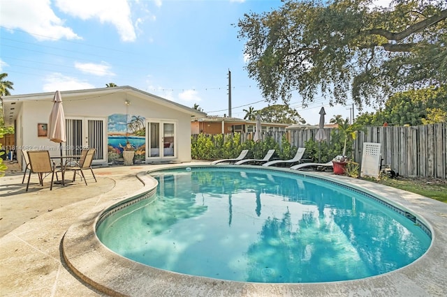 1547 NE 38th St, Oakland Park, FL 33334 - view of pool featuring french doors and a patio area