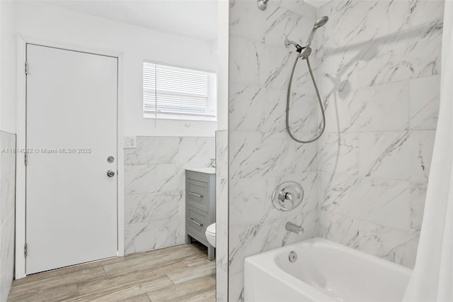 1547 NE 38th St, Oakland Park, FL 33334 - bathroom with tile walls, shower / bath combination, toilet, vanity, and wood finished floors