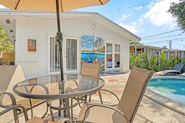 1547 NE 38th St, Oakland Park, FL 33334 - view of patio / terrace featuring french doors and outdoor dining area